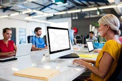 Casual business people working on computer