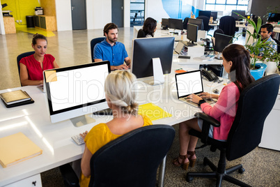 Casual business people working on computer