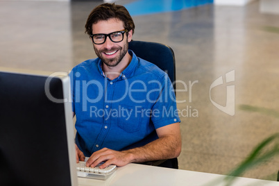 Casual businessman working on computer Casual businessman working on computer