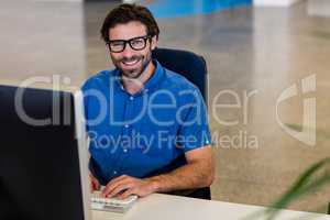 Casual businessman working on computer