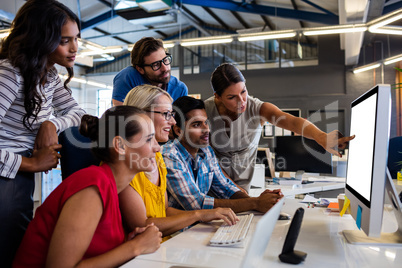 Casual business team working on one computer