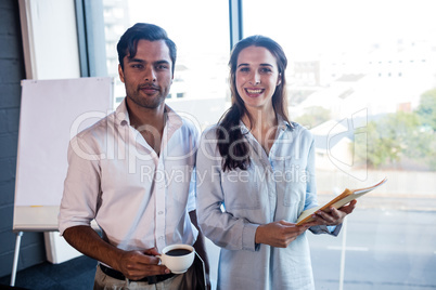 Colleagues with coffee and documents