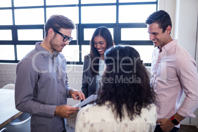 Group of hipster interacting and reading a document