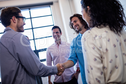 Group of hipster interacting and handshaking