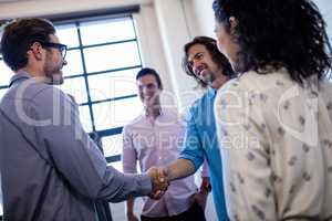 Group of hipster interacting and handshaking