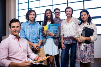 Portrait of a group of coworkers holding folders