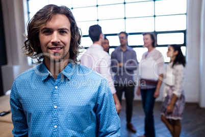 Portrait of a hipster and group of coworkers