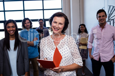 Portrait of a group of coworkers holding folders