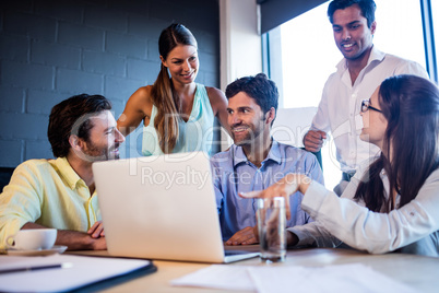 Group of coworkers interacting around a table