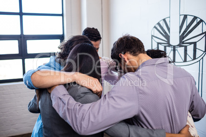 Group of coworkers arms in arms