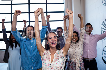 Group of coworkers hands up
