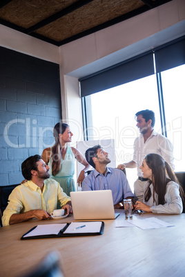 Coworkers interacting around a table