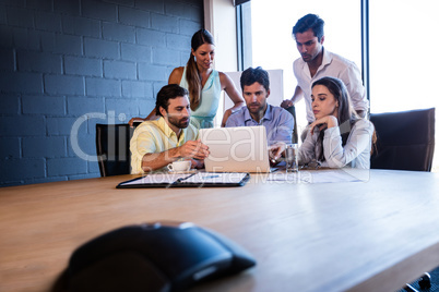 Coworkers working together on a laptop