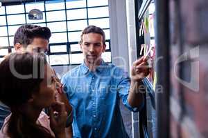 Hipsters reading a post it on a window