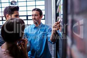 Hipsters reading a post it on a window