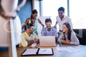 Group of coworkers using a laptop