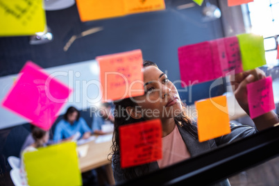 Hipster reading a post it on a window