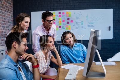 Group of colleagues watching a computer