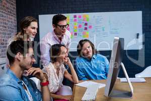 Group of colleagues watching a computer