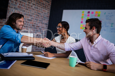 Group of hipster interacting and handshaking