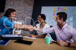 Group of hipster interacting and handshaking