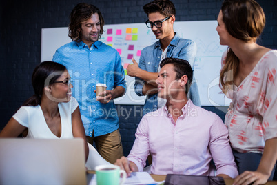 Group of coworkers interacting Group of coworkers interacting