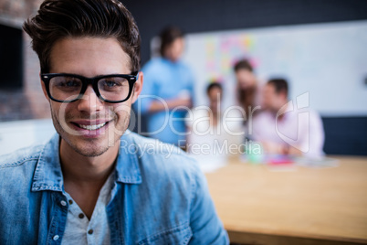 Portrait of a hipster and group of coworkers