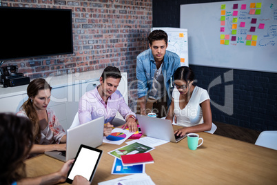 Manager leading a meeting with a group of creative designers