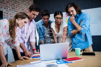 Group of designers working on a computer