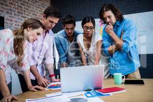 Group of designers working on a computer