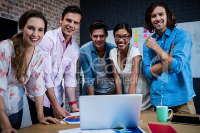 Group of designers working on a computer