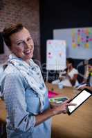 Portrait of a casual businesswoman using a tablet computer