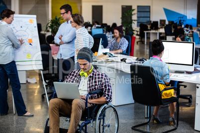 Designer in a wheelchair with a computer