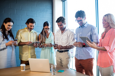 Group of colleagues using tablet computer