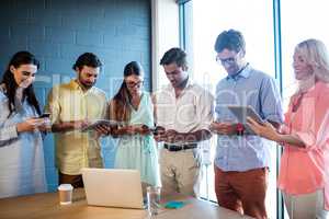 Group of colleagues using tablet computer