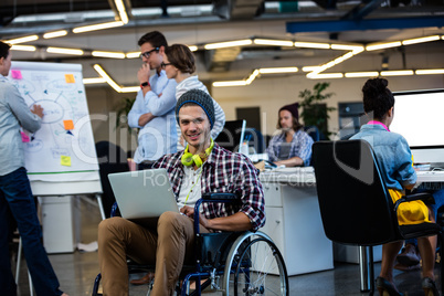 Designer in a wheelchair with a computer