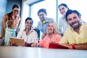 Group of coworkers using a tablet computer