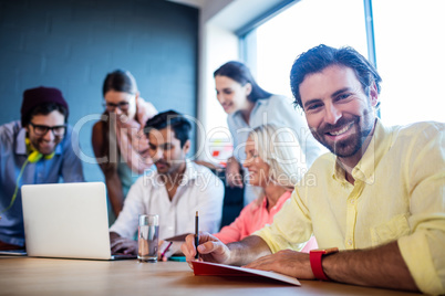 Group of coworkers using a laptop