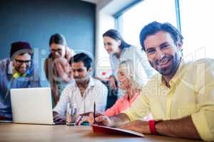 Group of coworkers using a laptop