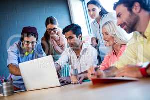 Group of coworkers using a laptop