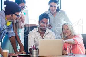 Group of coworkers using a laptop