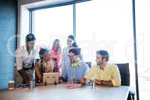 Group of coworkers using a tablet computer