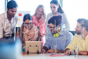 Group of coworkers using a tablet computer