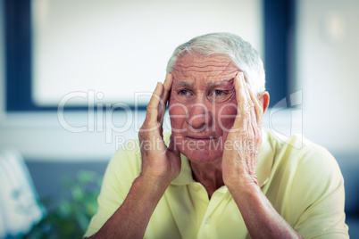 Senior man suffering from headache