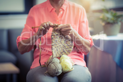 Senior woman knitting wool
