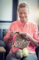 Senior woman knitting wool