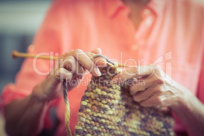 Senior woman knitting wool