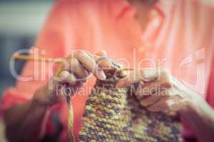 Senior woman knitting wool