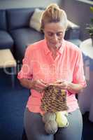 Senior woman knitting wool