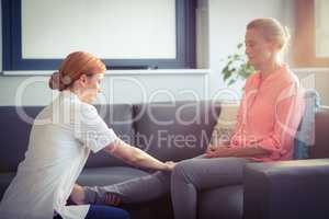Nurse giving leg massage to woman